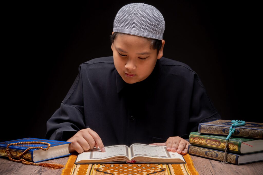 vecteezy a little asian muslim boy is sitting and reading the quran 52112766 scaled